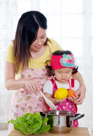 Asian mother and daugther in the kitchenの写真素材