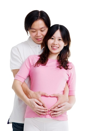 Asian making the sign of love on his pregnant wife stomachの写真素材