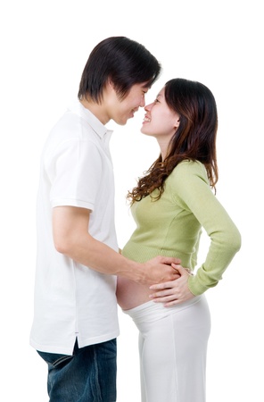 Asian man holding his pregnant wife belly isolated on white background の写真素材