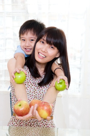 Healthy eating concept  mother and son holding applesの写真素材