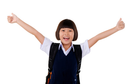 Primary school girl raise her handsの写真素材