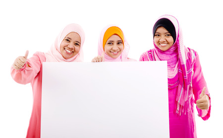 Muslim women holding a white boardの写真素材