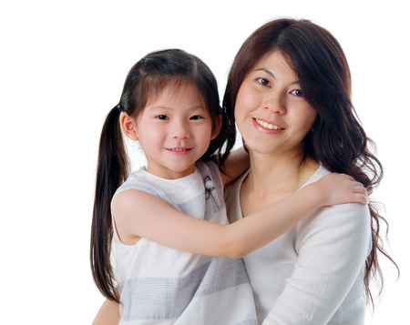 asian girl hugging her motherの写真素材