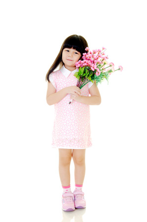 Cute asian girl posing with flowers isolated on white の写真素材