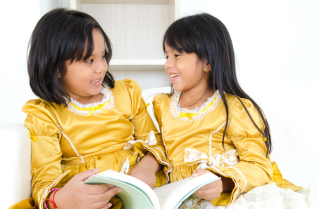 Indian kids sharing a bookの写真素材