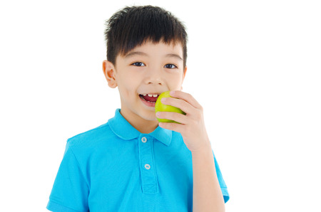 Asian boy eating appleの写真素材