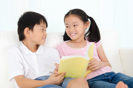 Asian kids shared a bookの写真素材