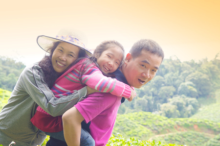 Asian family having piggyback funの写真素材