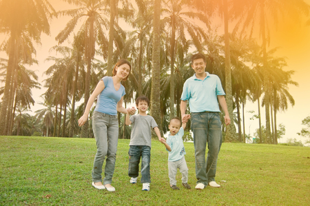 Asian family walking in the parkの写真素材