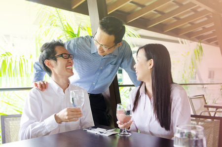 Asian business team having discussion in the restaurantの写真素材