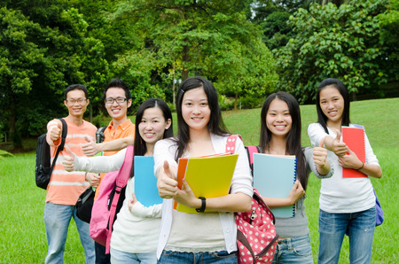 Asian college students raised their thumbs upの写真素材
