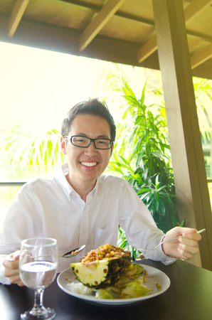 Young asian executive having thai food in the restaurantの写真素材