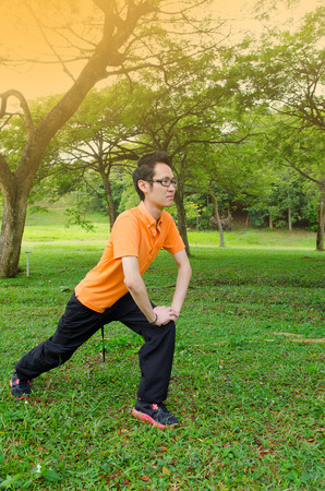 Young asian adult exercise in the parkの写真素材