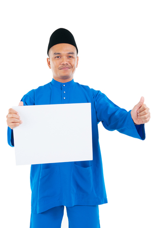 Muslim man holding a white board and raised his thumb upの写真素材