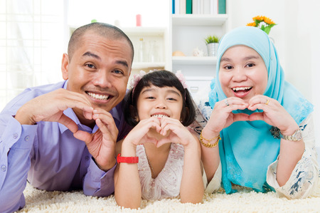 Malay family making love shape with handsの写真素材