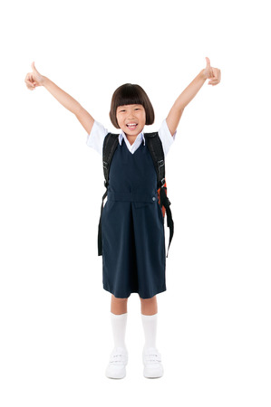 Asian primary school girl raised her thumbs up. Education concept.の写真素材