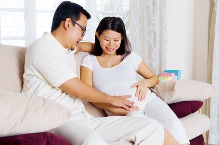 Asian man and his pregnant wifeの写真素材