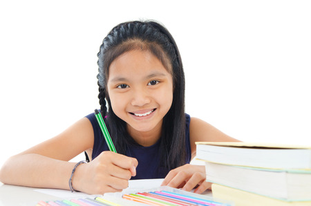 Asian child drawing with colored pencilの写真素材