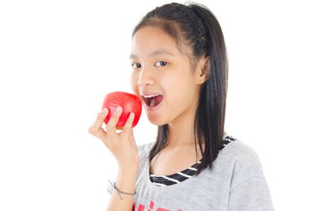 Lovely asian girl eating appleの写真素材