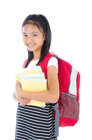 Asian school kid carry school bag and holding booksの写真素材