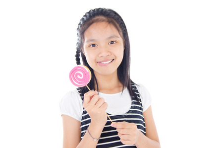 Cute asian girl eating lollipopの写真素材