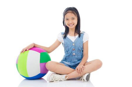 Asian girl sitting on the floor with a ballの写真素材