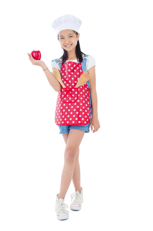Asian girl wearing apron and holding a capsicumの写真素材