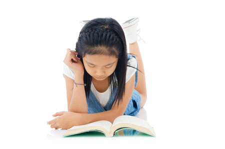 Asian girl reading on the floorの写真素材