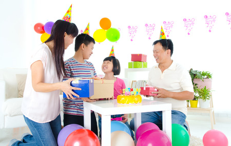 Asian family enjoying birthday party at homeの写真素材