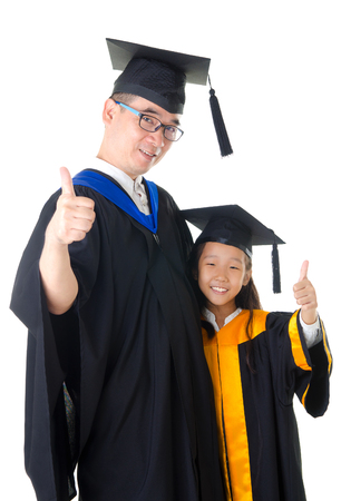 Asian father and daughter in graduation gownの写真素材