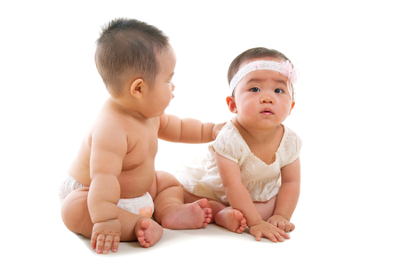 Indoor portrait of lovely asian babies on white backgroundの写真素材