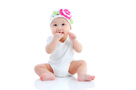 Indoor portrait of lovely asian baby sitting on the floorの写真素材