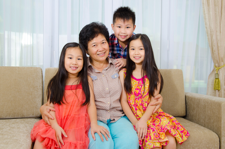 Indoor portrait of asian senior woman and her lovely grandchildren