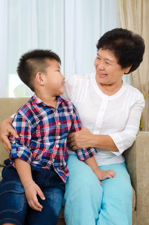 Indoor portrait of asian senior woman and grandchildの写真素材