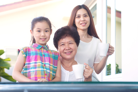 Asian senior woman relax in the garden together with daughter and grandchildの写真素材
