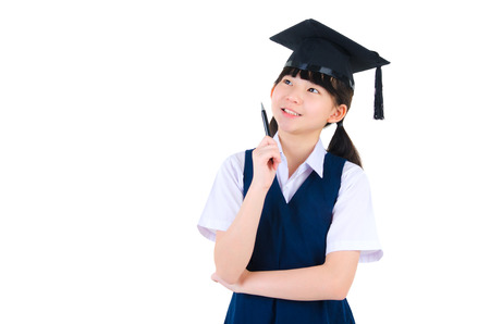 Asian primary school girl wearing mortarboard having thoughtの写真素材