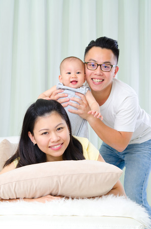 Indoor portrait of cheerful asian familyの写真素材