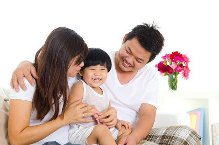 Indoor portrait of asian family in the living roomの写真素材
