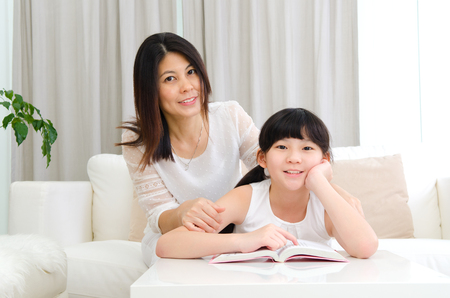 Asian mother and daughter in the living roomの写真素材