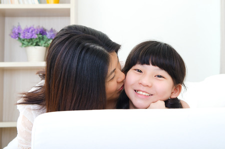 Asian woman kiss her daughterの写真素材
