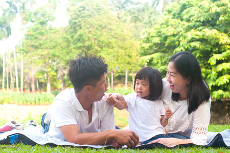 Asian family enjoying outdoor nature in the beautiful morning sunlight.の写真素材