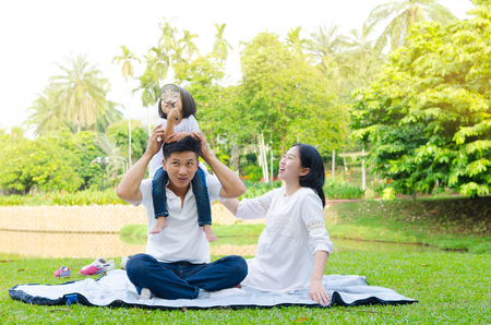 Asian family enjoying outdoor nature in the parkの写真素材