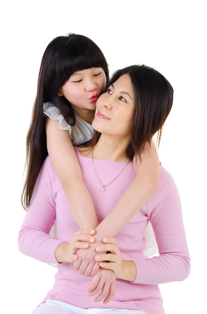 Asian girl hug and kiss her motherの写真素材