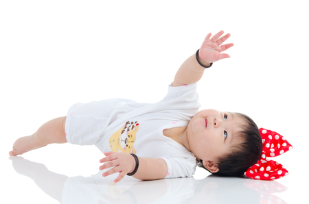 Asian baby lying on the floorの写真素材