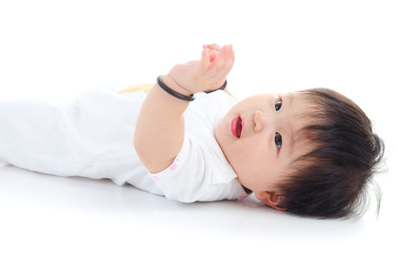 Lovely asian baby lying on the floorの写真素材