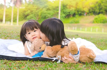 Asian girl kiss her little sisterの写真素材