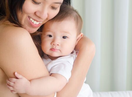 Indoor portrait of asian woman and her babyの写真素材