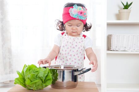 Little asian child enjoy cookingの写真素材