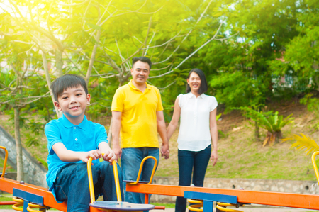 Asian family at the playgroundの写真素材