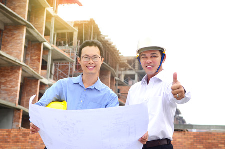 Asian engineers posing at the construction siteの写真素材